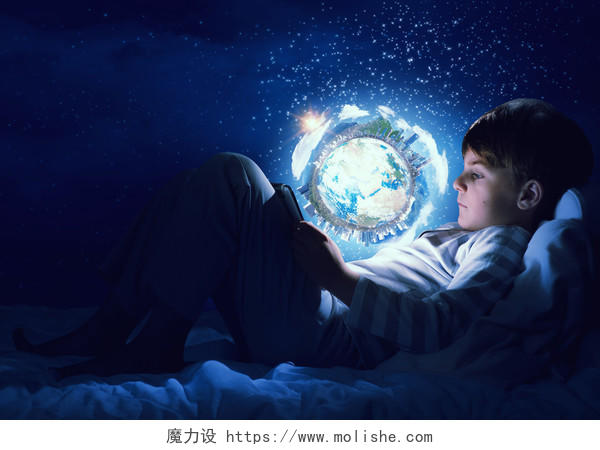 可爱的男孩在床上看着发光的地球行星
